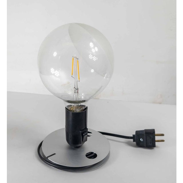 We are selling this cool Mid-Century Modern Italian table lamp by Flos. This Lampadina lamp was designed by Achille...