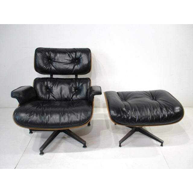 A rich Rosewood and soft black leather 670 lounge chair and 671 ottoman with cast aluminum star bases . This Mid Century...