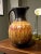 Hand-thrown and signed by American studio potter Richard Aerni, this 11" x 7" pitcher-form vase showcases his celebrated...