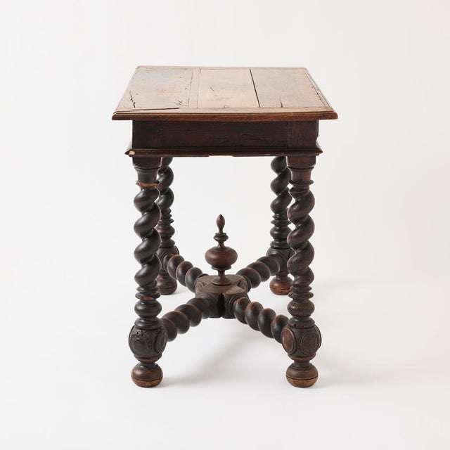 - This sculptural antique table features beautiful turned legs, a central finial, rich finish, and strong presence that...