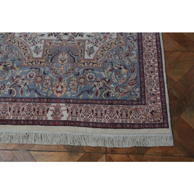 Hand-knotted abriz rug with an atypical pattern. Rich floral decor. Central field in a blue base with an oval medallion...