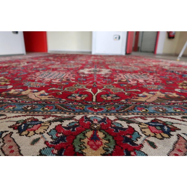 A magnificent antique Tabriz rug from the 1920s — hand-knotted in the great workshop tradition of Tabriz, northwestern...