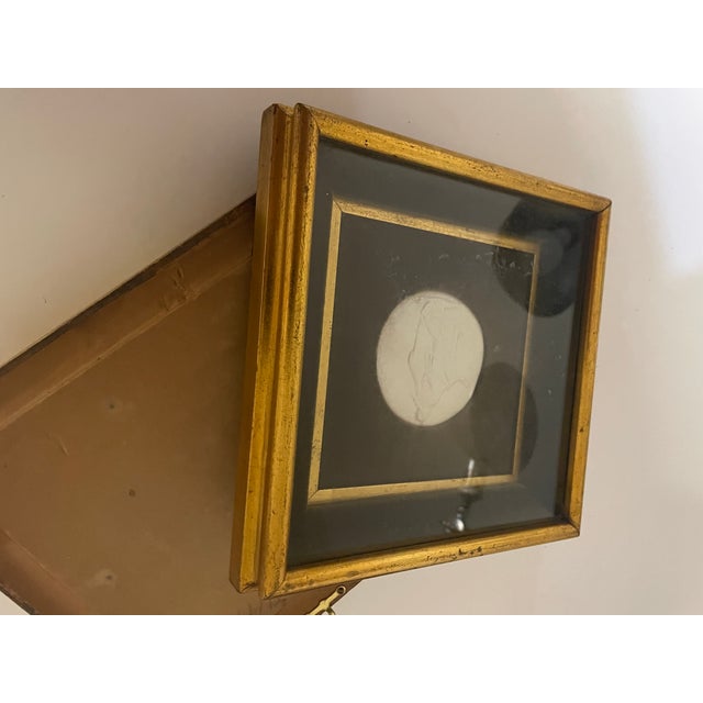 This is an antique pair of Italian intaglios from the 19th century, with custom gilt frames. The intaglios are original...