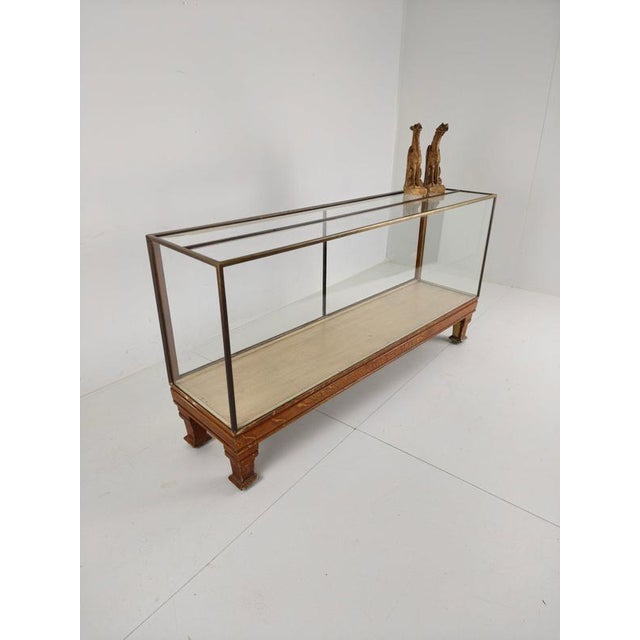 This charming antique English brass counter, made circa 1920, was originally used in a clothing store. It features yard...