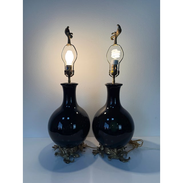 Elegant and timeless, this pair of 1980s Chapman table lamps features bold black glazed ceramic bodies with a sleek, high-...