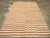 This Mid-20th century Turkish Flatweave Kilim rug, features a bold yet minimalist striped design in a warm palette of...