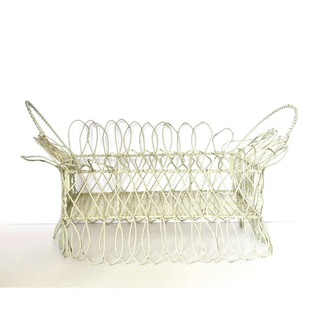 An antique 19th-century Victorian rectangular planter fashioned out of white-painted twisted metal wire, with scalloped...