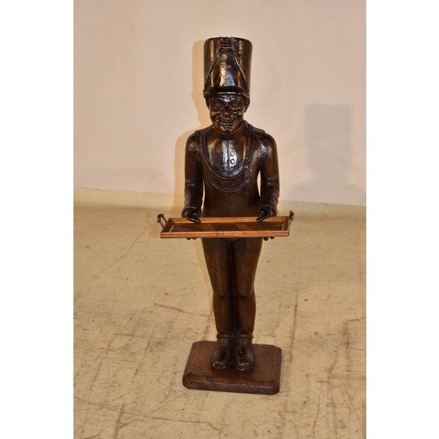 19th century unique folk art statue of a French soldier holding a tray. The statue is hand carved from walnut and is such...