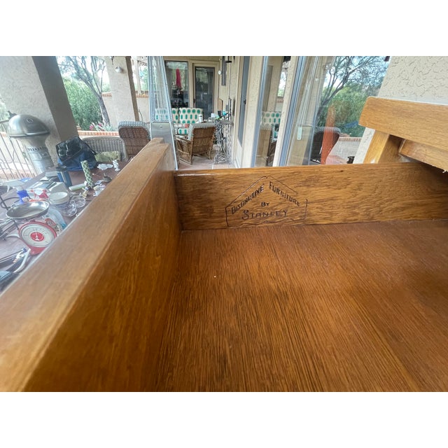 Here is a mid century cherry wood and white laminite top made by Stanley Furniture. There is a single drawer and an open...