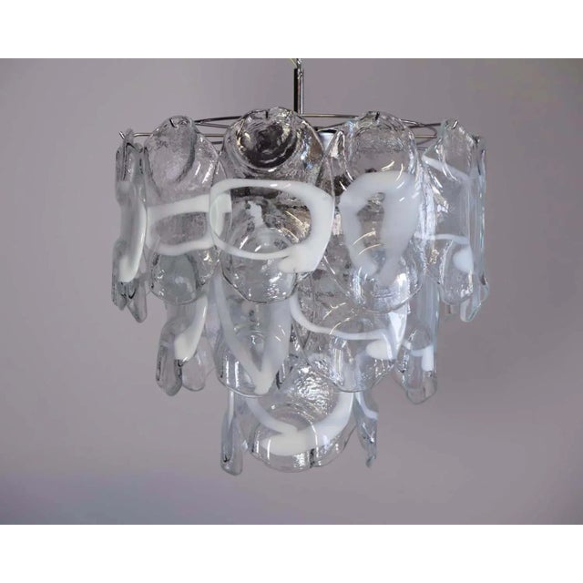 Vintage Italian Murano chandelier in Vistosi style. The chandelier has 23 fantastic Murano white and transparent glasses...