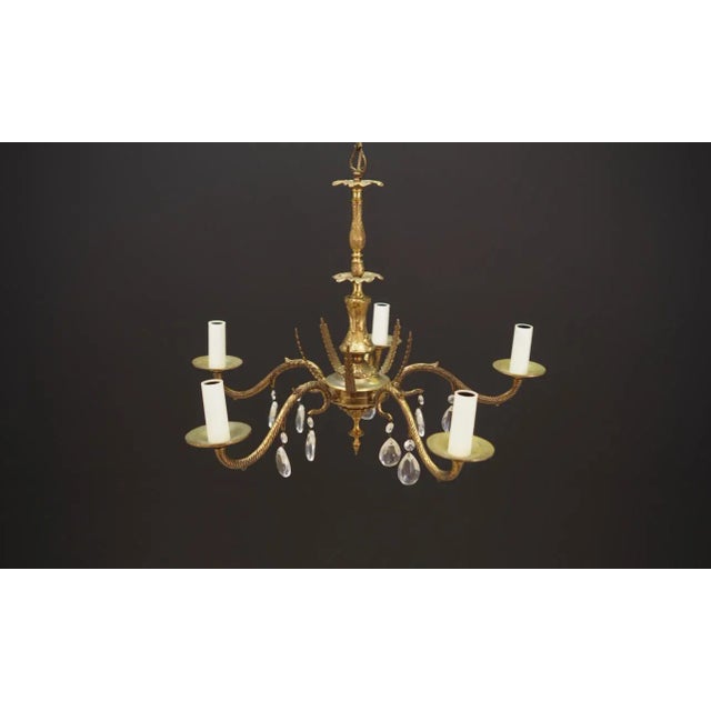 The chandelier was made in the 1960s, Danish production. Made from a combination of brass and glass. Condition: Chandelier...