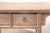 A charming antique Chinese hall table crafted from solid elmwood, dating to the late Qing dynasty. The rectangular top...