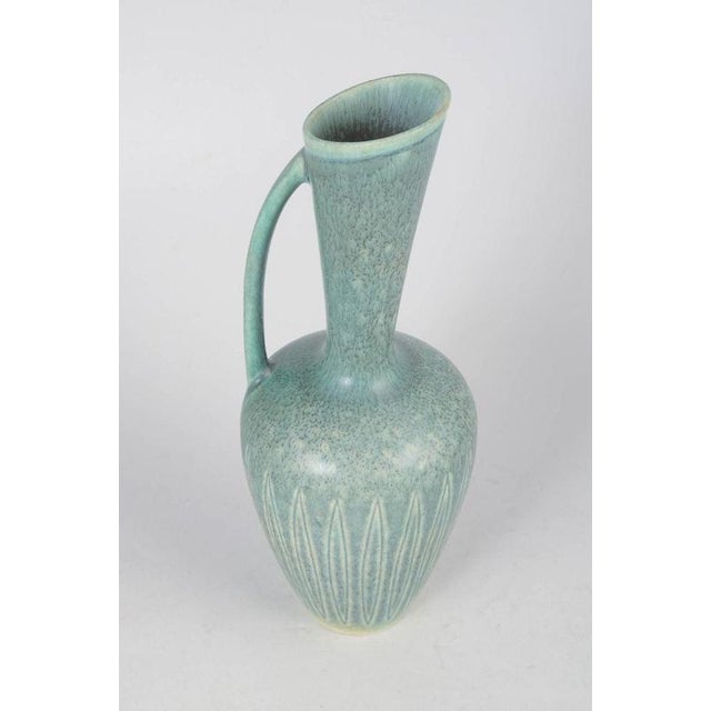 Gunnar Nylund for Rörstrand, stoneware pitcher. Elegant tall first-quality pitcher with fluted body, slender neck, and...