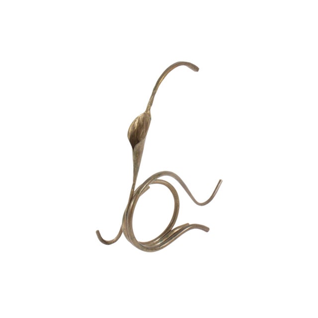 A hand-foraged calla lily candle holder by the American artist and blacksmith Jack Brubaker. This vine-like candle holder...