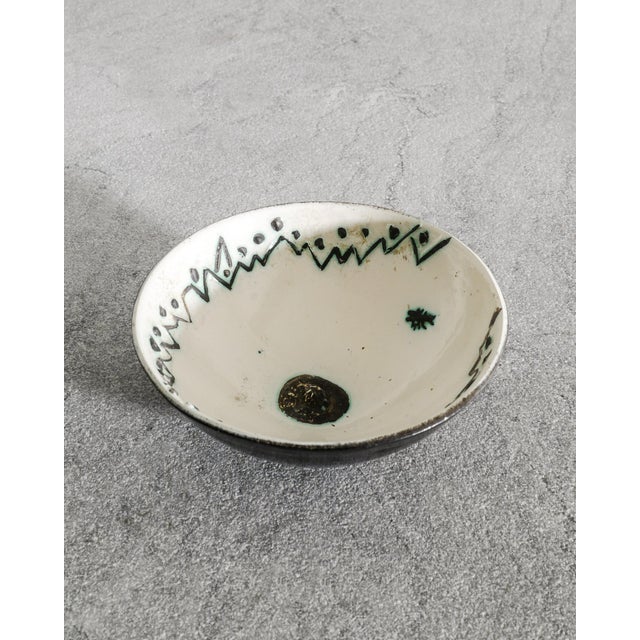 A very rare French mid century ceramic bowl in a black enammel and white green painted inner decor by Pablo Picasso...
