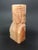A vintage hand carved Aztec figure made from onyx stone in a warm amber-yellow shade. The natural variations in the stone...