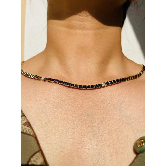 This is part of Chairish’s Fine Jewelry assortment. Blue Sapphire Necklace in 18K Gold studded with square cut sapphire...