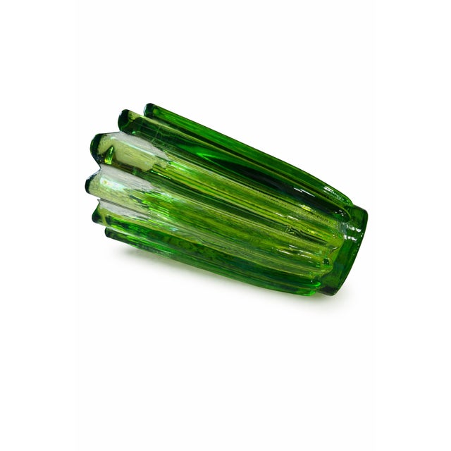 A striking mid-century emerald green art glass vase featuring a dramatic ruffled rim and deeply ribbed interior. The...