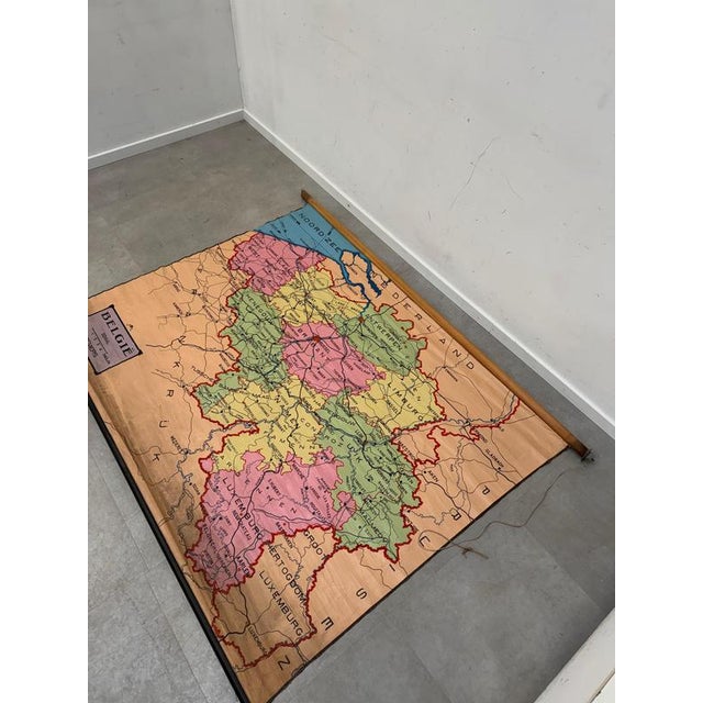 Original vintage school wall map depicting Belgium and its surrounding regions, including parts of France, the...