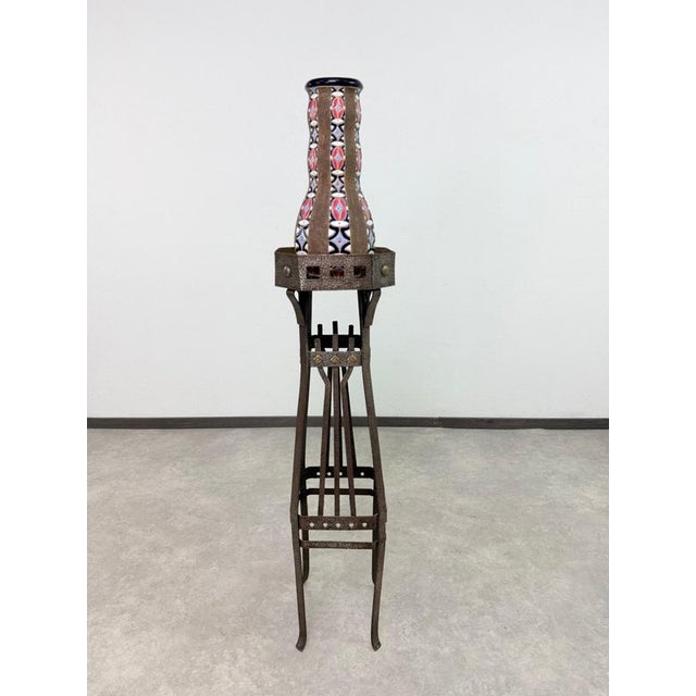 An exceptional and highly architectural antique Art Nouveau plant stand (pedestal), masterfully crafted from wrought iron...