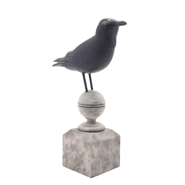 Carved & painted wood confidence crow decoy with glass eyes. Mounted on a period fence post finial. American, circa...