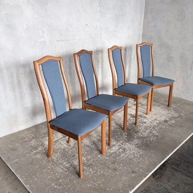 a refined set of four danish dining chairs by skovby, dating from the 1970s. Their sculptural high backs, warm teak and...