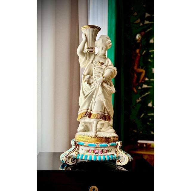 Elegant French bisque porcelain candlesticks from the 19th century, modelled as an aristocratic couple in 18th century...