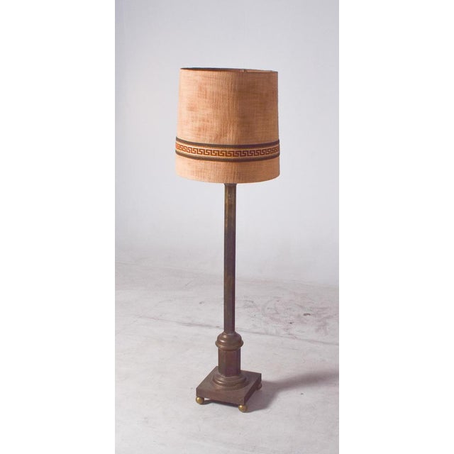 This Danish floor lamp combines elegance and functionality, featuring a solid brass structure and a tall, slender column...