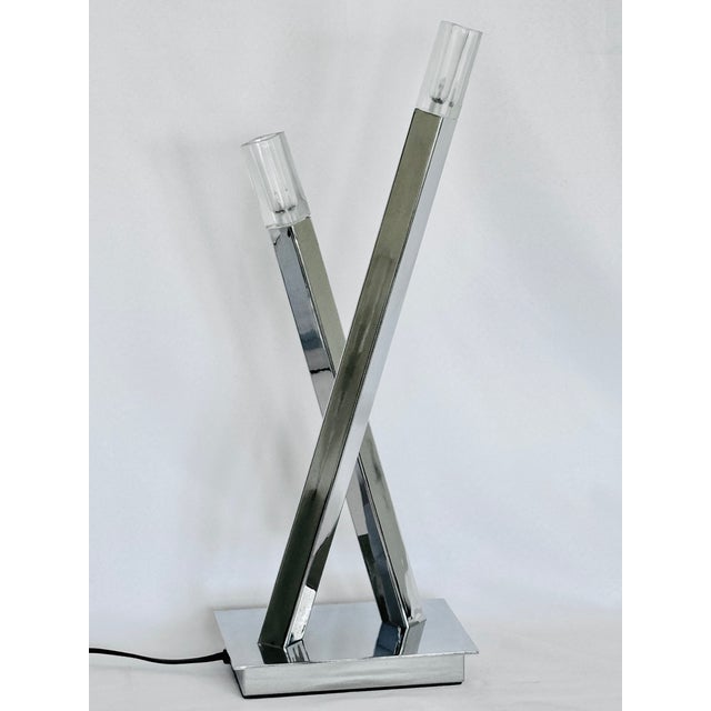 A pair of nickel plated post modern lamps. Retains original label “F Ramond”, Frederick Ramond lighting from the 80’s.