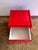 Exceptionally rare modern night table in bright red that perfectly embodies the warm colours, soft lines, and...