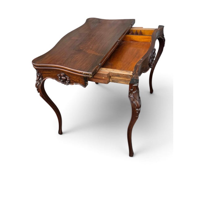 This 19th Century French Gabriel Legs Rosewood Inside Black Leather Game Table is a stunning piece of antique furniture....