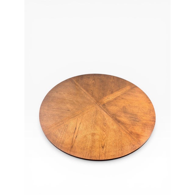 A beautifully crafted round game table by Henredon, featuring a striking four-panel starburst oak veneer top and a...