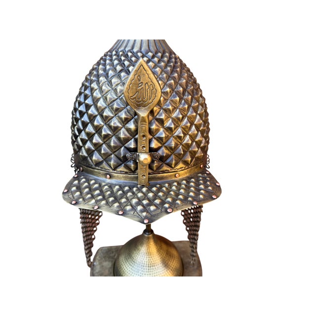 This brass helmet is a physical record of intense manual labor. It is not cast from a mold; it is born from a flat sheet...