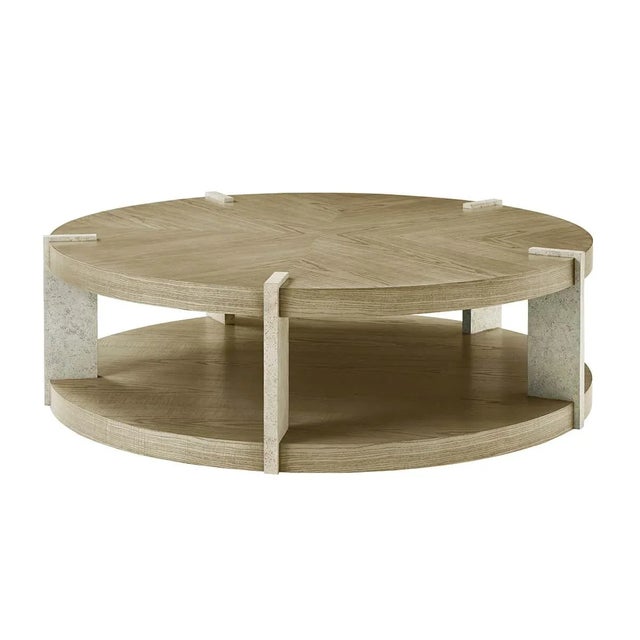 A Round cocktail table is a tranquil and elegant addition to any living room. It features figured cathedral ash...