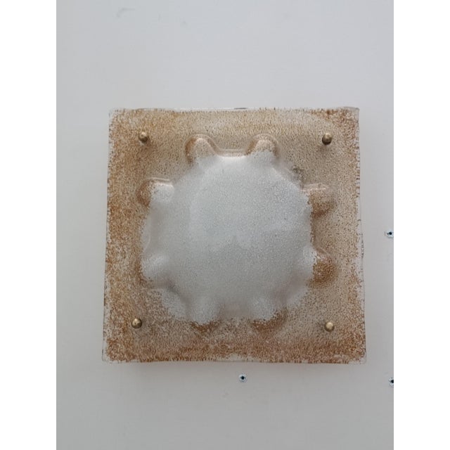 Magnificent and timeless wall sconce by Mazzega. Italy, 1970s. White lacquered metal frame. It supports a beautiful...