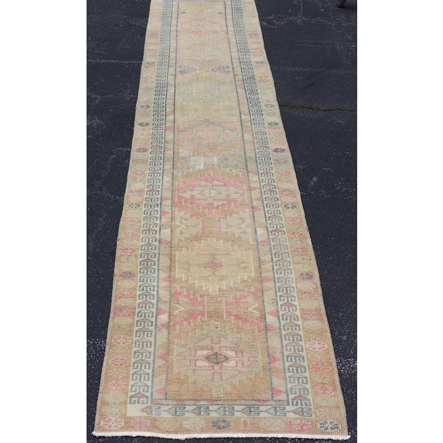 Measures: 2'8 x 13'. Turkish Oushak Runner in Soft Taupe with Faded Rose, Pale Blue, and Cream Accents. Keivan Woven Arts...