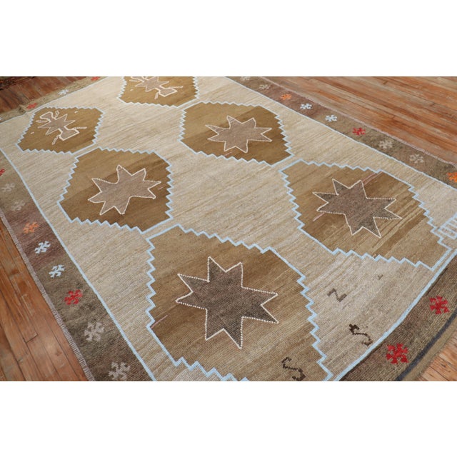 A room-size geometric Turkish kars rug from the middle of the 20th century with 6 large brown medallions on a camel-...