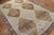 A room-size geometric Turkish kars rug from the middle of the 20th century with 6 large brown medallions on a camel-...