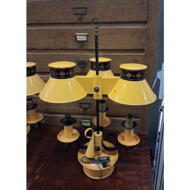 Pair of Empire-style three-light hot-water bottle lamps made of lacquered sheet metal with a candle snuffer A charming...