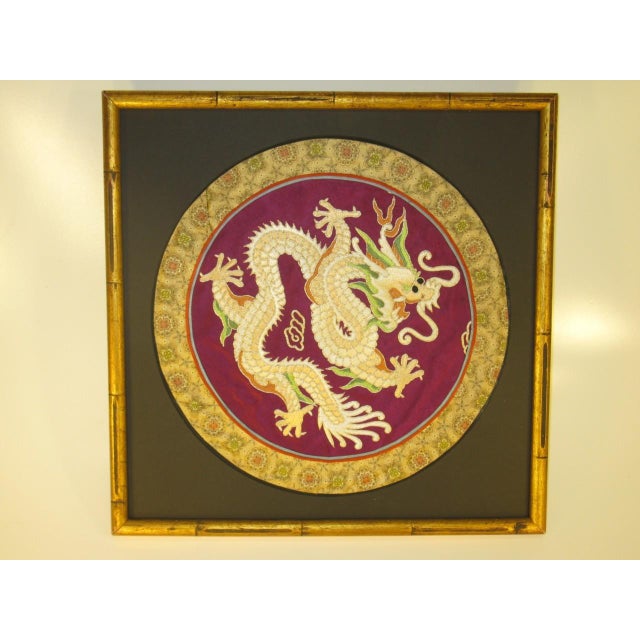 This Chinese embroidered dragon gold frame is a silk and fabric kimono or robe from the late 19th century. The intricate...