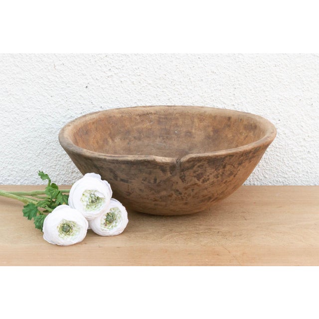 There is something deeply grounding about holding a vessel that was hewn by hand from a single block of wood. This antique...