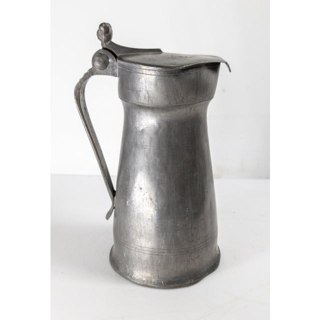 We are selling this 19th century Continental European pewter pitcher. This pitcher has nice simple form with acorn form...