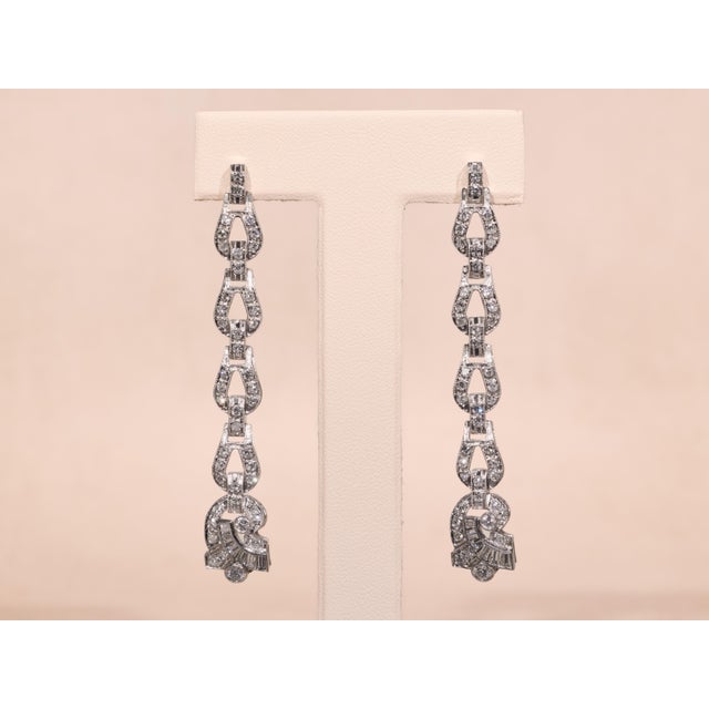 The Daenerys Antique Platinum and Diamond Dangler Earrings. The earrings are set with 2.60 carats of old cut diamonds...