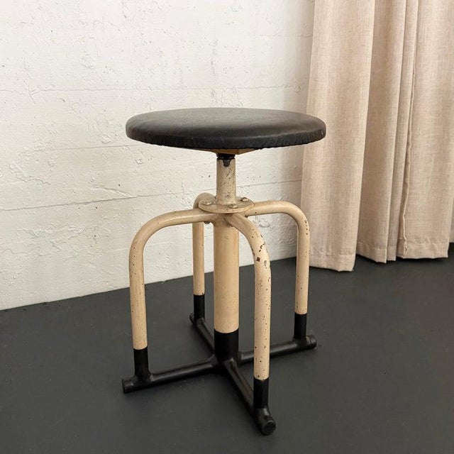 This handsome, early 20th century, industrial, apothecary stool is circa the 1930s. The stool combines a bent tubluar...