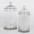 A set of two French hand-blown clear glass lidded apothecary or candy jars. Smooth canister form, domed lid with knob....