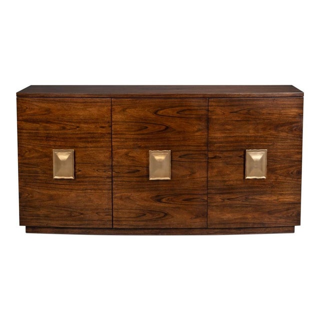 Horizontal wood grain leads the design of a long, low three-door case. The horizontal grain runs unbroken across the flat...