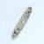 This elongated brooch features intricate filigree work with a central old European cut diamond, surrounded by delicate...