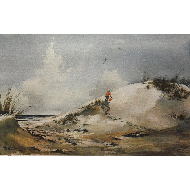 Evocative lithograph portraying a solitary figure on a sand dune, their orange attire providing a focal point in the...