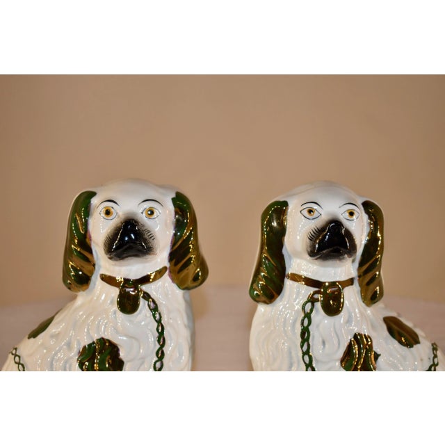 Pair of 19th century Staffordshire spaniels from England. this is a lovely pair, decorated in copper lustre painting and...
