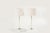 A gorgeous set of table lamps in the style of Charles Hollis-Jones, featuring a tubular glass stem, brass, and lucite...